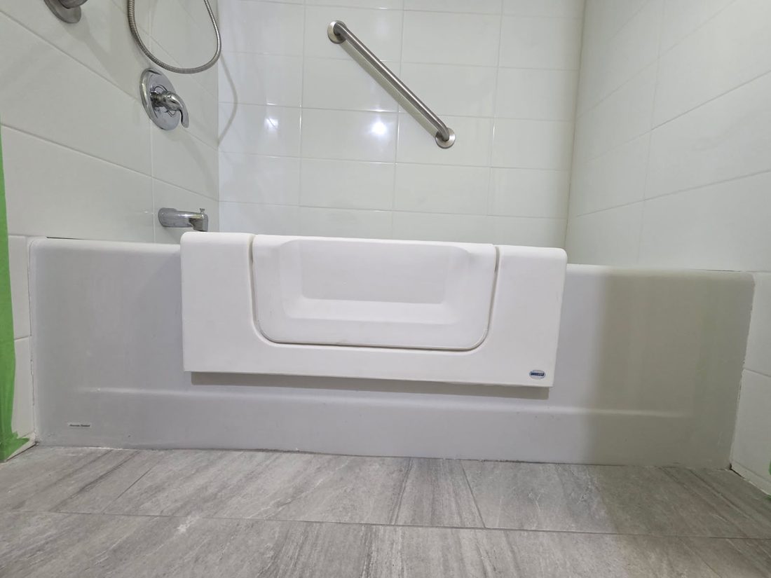 A tub step-through cut-out with a stainless grab bar, Quinte West
