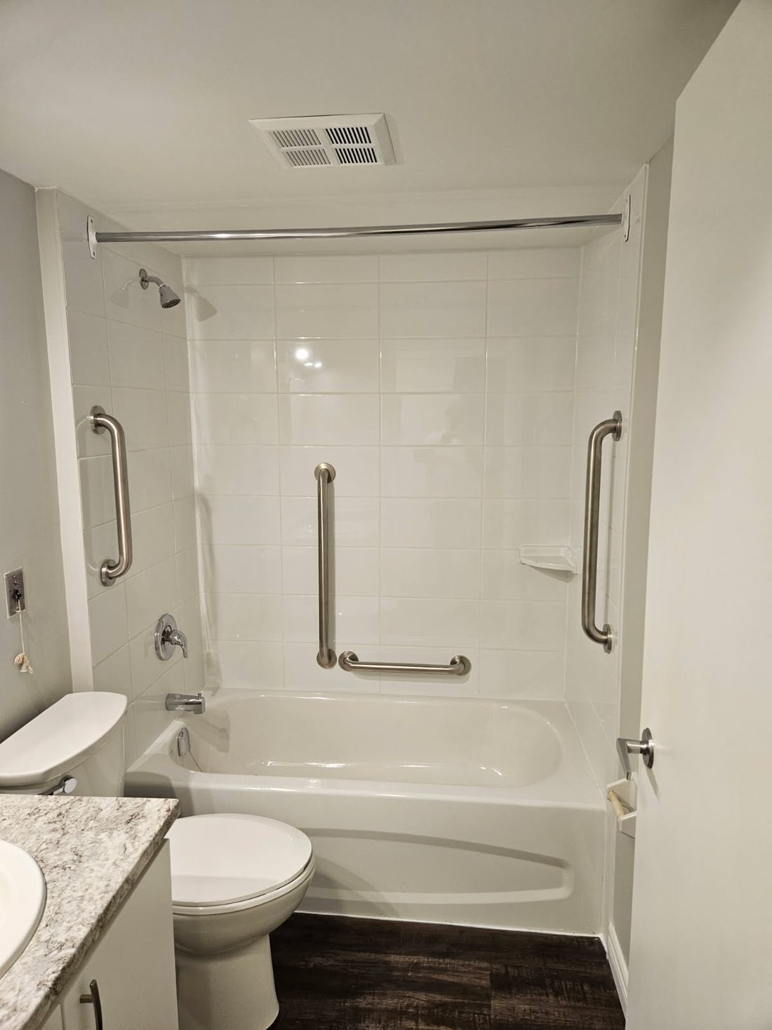 A finished tub-to-shower conversion with a grab bar in Trenton, Ontario